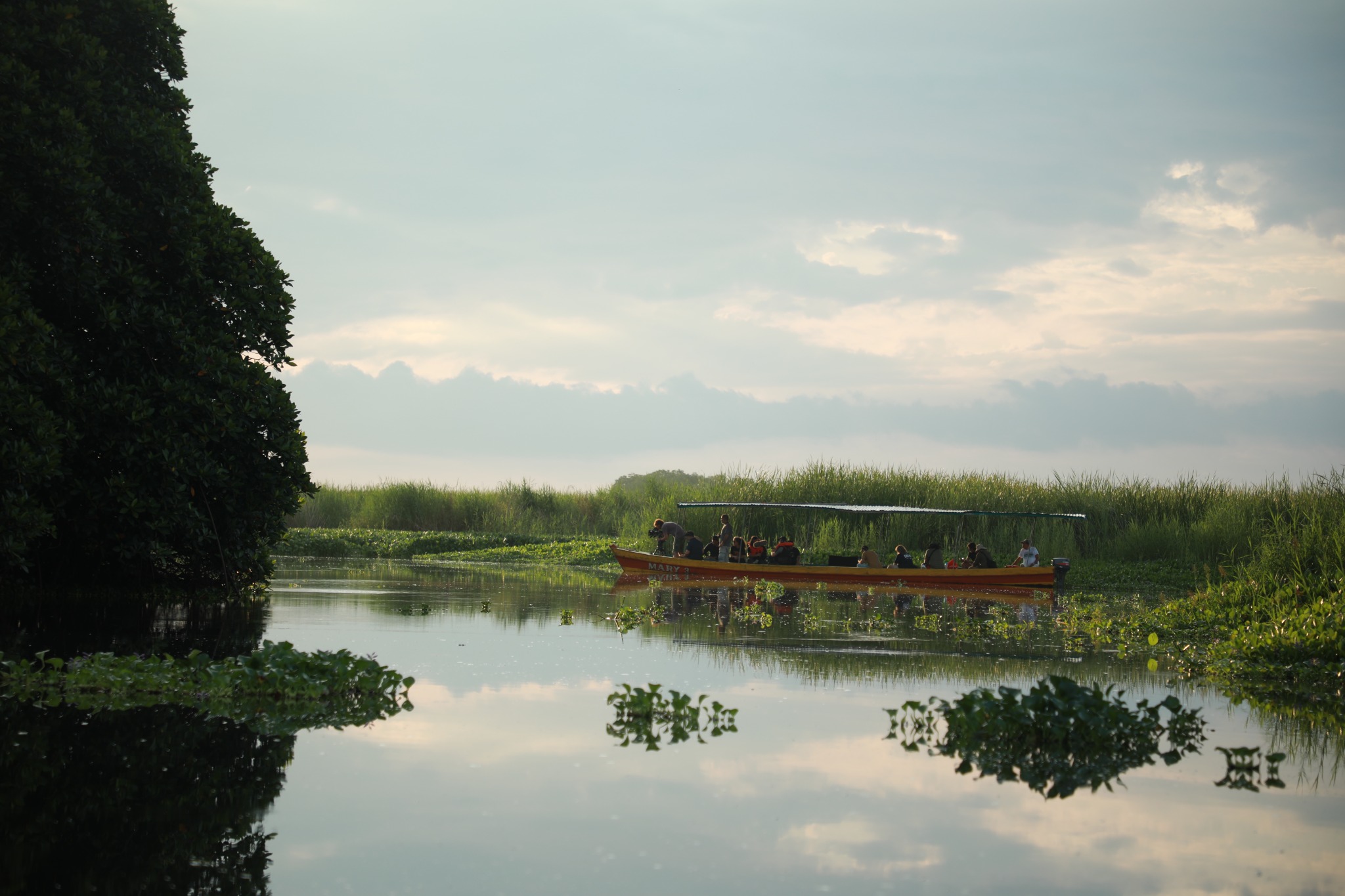 A film crew travelling by boat through the wetlands of Guatemala's Pacific coast